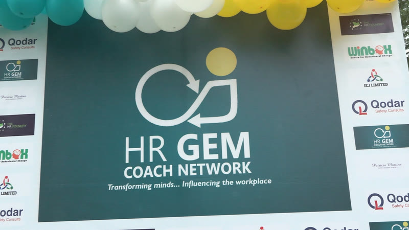 The HR GEM Coach Network event backdrop framed with balloons