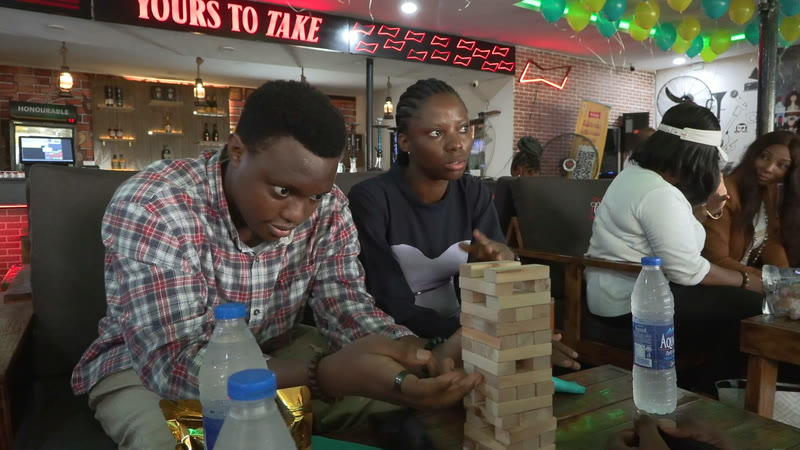 Members gathered around a game of Jenga
