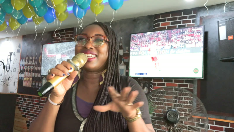 A member sharing her story into a microphone