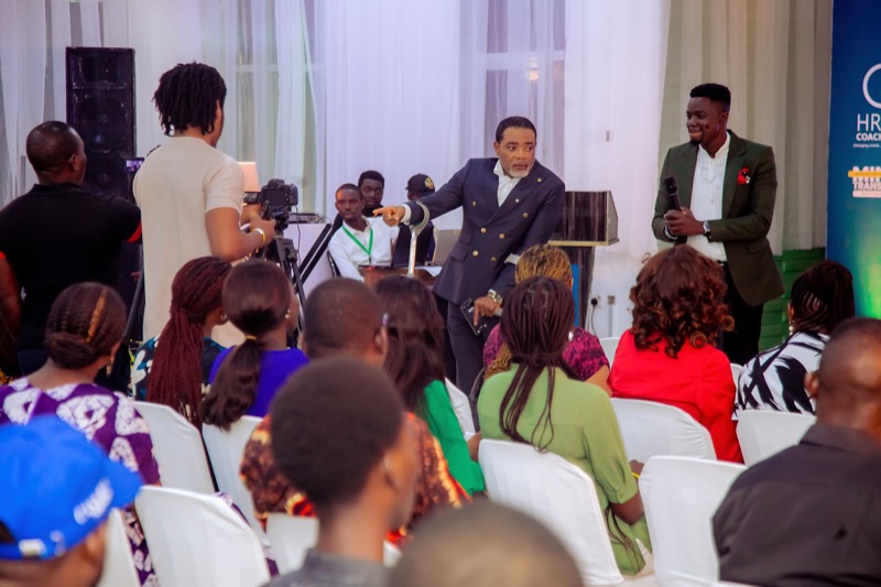 A speaker walking among the seated audience