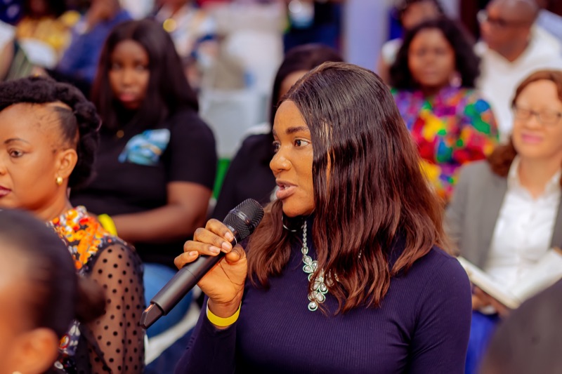 An attendee asking a question into a microphone
