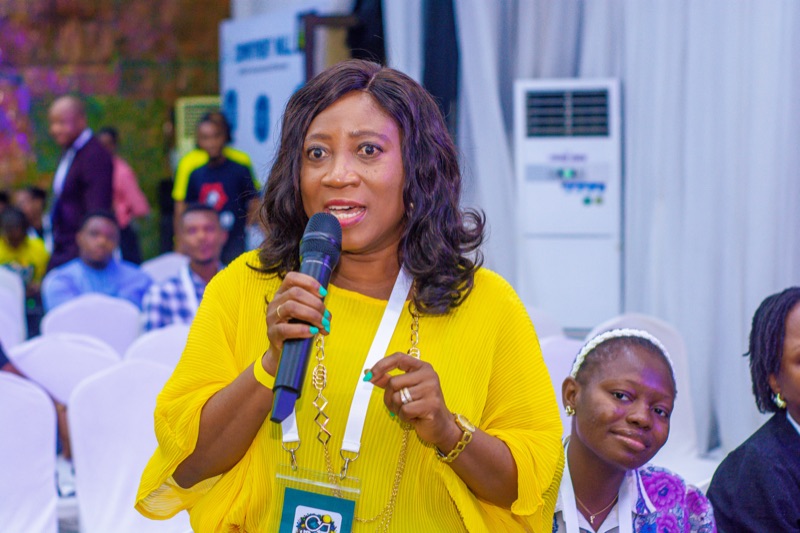 An HR GEMs member sharing her thoughts into a microphone at the 2026 event